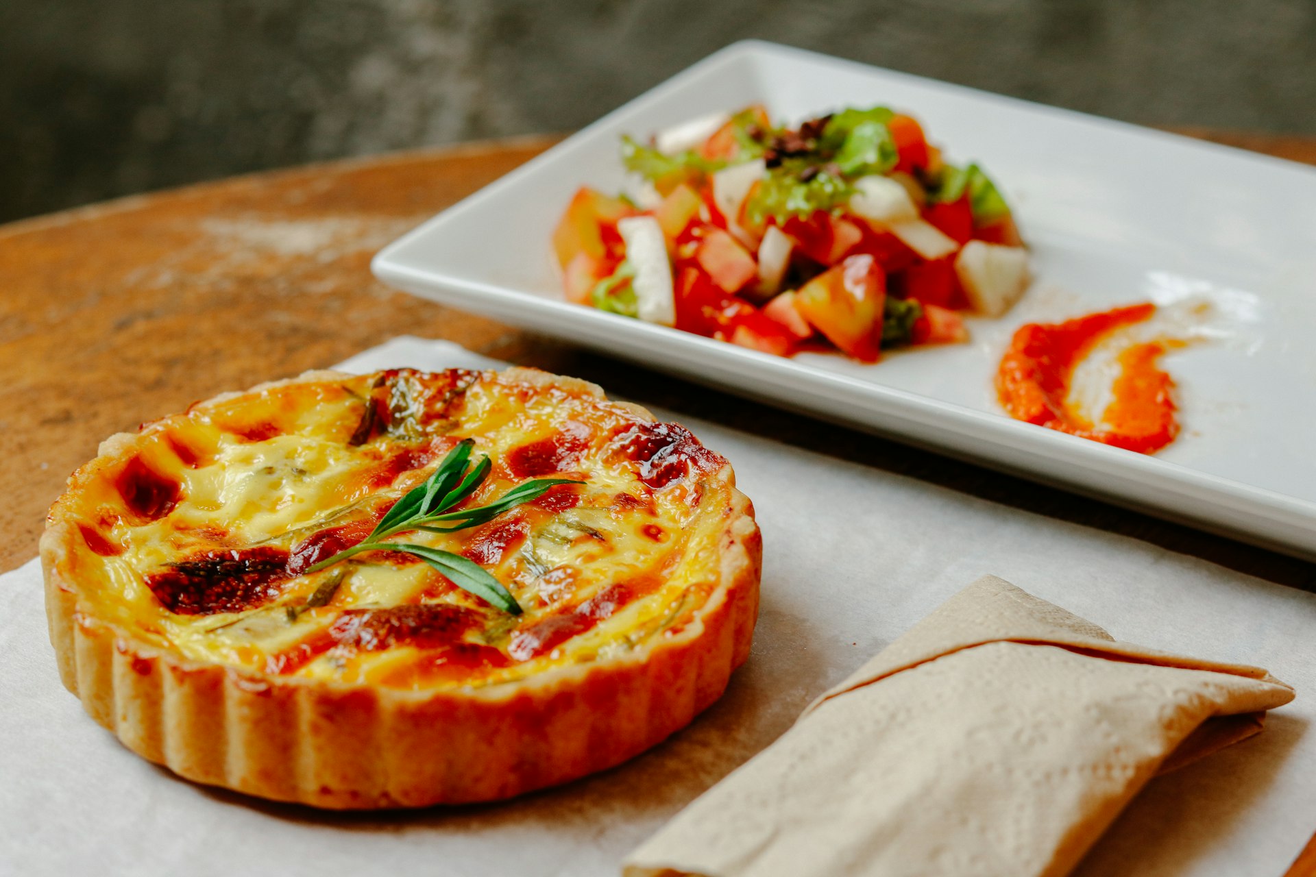 pizza with green leaf on white ceramic tray french food